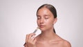 Makeup artist moisturizes skin with cream before applying makeup. Professional makeup and cosmetology skin care