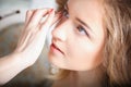 Makeup artist preparing bride before the wedding in a morning