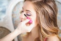 Makeup artist preparing bride before the wedding in a morning Royalty Free Stock Photo