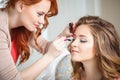 Makeup artist preparing bride before the wedding in a morning Royalty Free Stock Photo