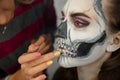 Makeup artist puts greasepaint of a nice lady