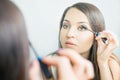 Makeup artist woman doing make-up using cosmetic brush for yourself Royalty Free Stock Photo