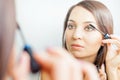 Makeup artist woman doing make-up using cosmetic brush for yourself Royalty Free Stock Photo