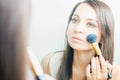 Makeup artist woman doing make-up using cosmetic brush for yourself Royalty Free Stock Photo