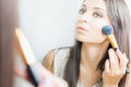 Makeup artist woman doing make-up using cosmetic brush for yourself Royalty Free Stock Photo