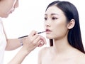 Makeup artist working on a female asian model Royalty Free Stock Photo