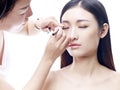 Makeup artist working on a female asian model