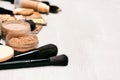 Makeup background. Make-up powder, foundation, concealer with brushes and cosmetic sponges on concrete surface with copy space Royalty Free Stock Photo
