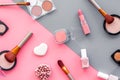 Makeup background with rounge, powder and tools on pink and grey table top view Royalty Free Stock Photo