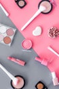 Makeup background with rounge, powder and tools on pink and grey table top view Royalty Free Stock Photo