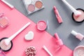 Makeup background with rounge, powder and tools on pink and grey table top view Royalty Free Stock Photo