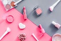 Makeup background with rounge, powder and tools on pink and grey table top view Royalty Free Stock Photo