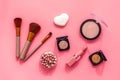 Makeup background with rounge, powder and tools on pink table top view Royalty Free Stock Photo