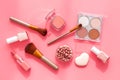 Makeup background with rounge, powder and tools on pink table top view Royalty Free Stock Photo