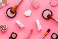 Makeup background with rounge, powder and tools on pink table top view Royalty Free Stock Photo