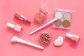 Makeup background with rounge, powder and tools on pink table top view Royalty Free Stock Photo