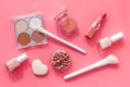 Makeup background with rounge, powder and tools on pink table top view Royalty Free Stock Photo