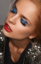 Makeup and beauty theme: beautiful girl with red lips and blue eyes in studio