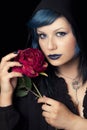 Makeup blue hair woman with black hood cap and rose Royalty Free Stock Photo