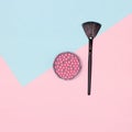 Makeup blush with make-up brush flatlay on pink and blue pastel background