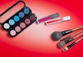 Makeup brush and cosmetics, on a color background Royalty Free Stock Photo