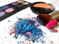 Crushed blue eyeshadow with cosmetic products