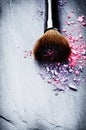 Makeup brush and crushed eye shadows Royalty Free Stock Photo