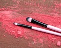Makeup brush and crushed eyeshadows on wooden background Royalty Free Stock Photo