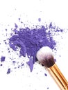 Makeup brush and crushed purple eyeshadows Royalty Free Stock Photo