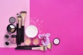 Makeup brush and decorative cosmetics and a orchid flower on pink background Royalty Free Stock Photo