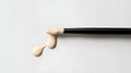 Makeup brush with foundation on a white background. Close-up. Royalty Free Stock Photo
