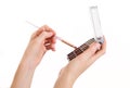 Makeup brush in a girl`s hand on a white background Royalty Free Stock Photo
