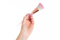 Makeup brush in a girl`s hand on a white background Royalty Free Stock Photo