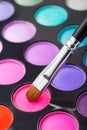 Makeup brush and set of colorful eye shadows Royalty Free Stock Photo