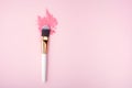 Makeup Brush on pink Background with Colorful Pigment Powder. Top view Royalty Free Stock Photo