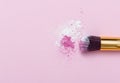 Makeup Brush on pink Background with Colorful Pigment Powder. Top view Royalty Free Stock Photo