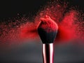 Makeup brush with red powder isolated on dark background Royalty Free Stock Photo