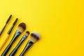 Makeup brushes and applicators arranged on a yellow background, ready for creating stunning beauty looks Royalty Free Stock Photo