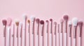 Collection of Professional Makeup Brushes Arranged on a Pastel Pink Background Royalty Free Stock Photo