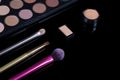 Makeup brushes on black background. Cosmetics, fashion, beauty, glamour. Accessories for make-up artist. Eyeshadow palette, Royalty Free Stock Photo