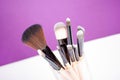 Makeup brushes close up on purple background Royalty Free Stock Photo