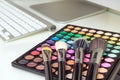 Makeup brushes on colorful makeup palette