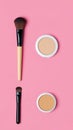 Makeup brushes and compact powder on pink background Royalty Free Stock Photo