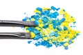 Makeup brushes with crushed compact blue and yellow eyeshadow