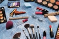 makeup brushes, decorative cosmetics, false eyelashes on a blue background. the view from the top