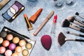 makeup brushes, decorative cosmetics, false eyelashes on a blue background. the view from the top