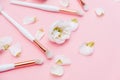 Makeup brushes and flowerss on white background. Horizontal view copyspace