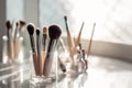 Makeup brushes in a glass. Clean professional makeup brushes set for make-up artist, cosmetics, make up theme. AI generated