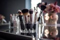 Makeup brushes in a glass. Clean professional makeup brushes set for make-up artist, cosmetics, make up theme. AI generated