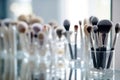 Makeup brushes in a glass. Clean professional makeup brushes set for make-up artist, cosmetics, make up theme. AI generated